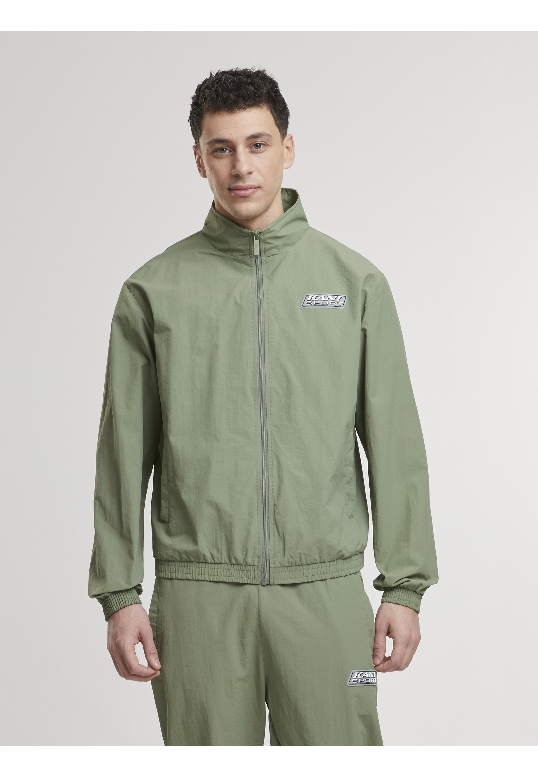 Karl Kani Trainingsjacke »Karl Kani Karl Kani Sport Patch Essential Trackjacket« 1 Stk. tlg. ohne Kapuze