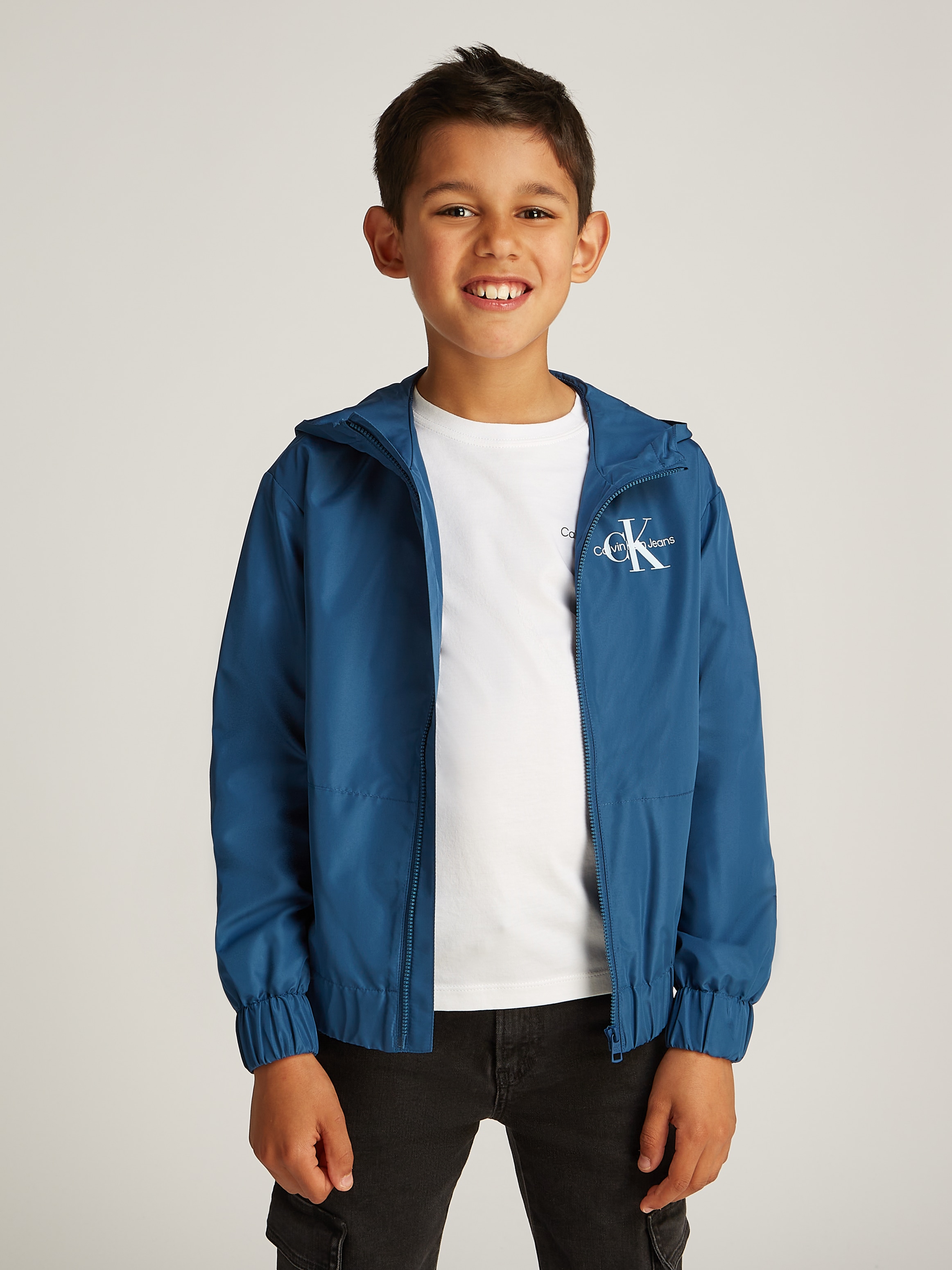 Windbreaker »MONOLOGO ESSENTIAL JACKET«, mit Kapuze, für Kinder bis 16 Jahre mit...